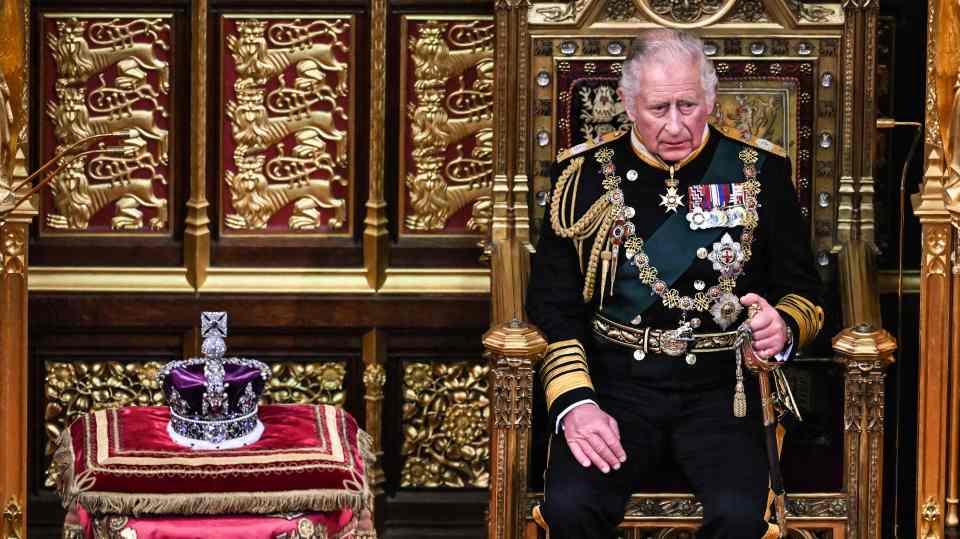 King Charles III is set to be crowned at Westminster Abbey next spring - pictured sat beside St Edward's crown