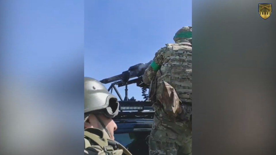 A Ukrainian machine gunner fires from an armoured vehicle