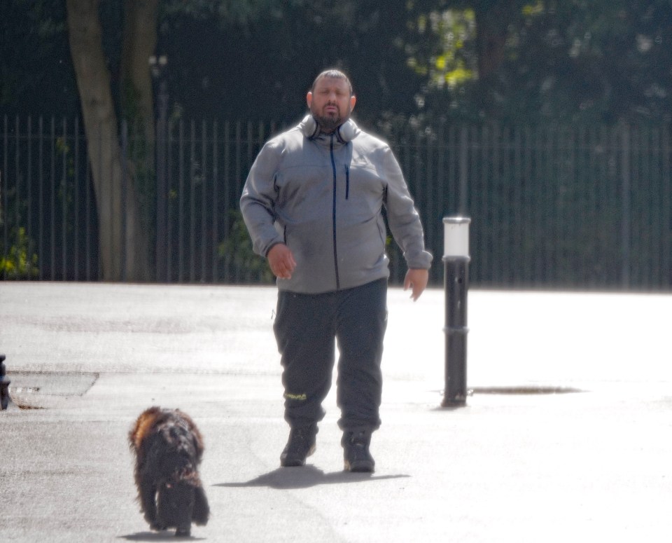 Naz seemed lost in thought on a shopping trip and walking his dog near his Berkshire home