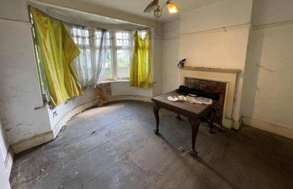 Ripped curtains and stained wallpaper adorn one room