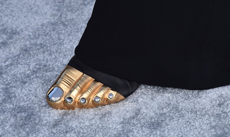 But the most unusual part of her outfit was her freaky golden shoes that resembled feet - completed with painted toes