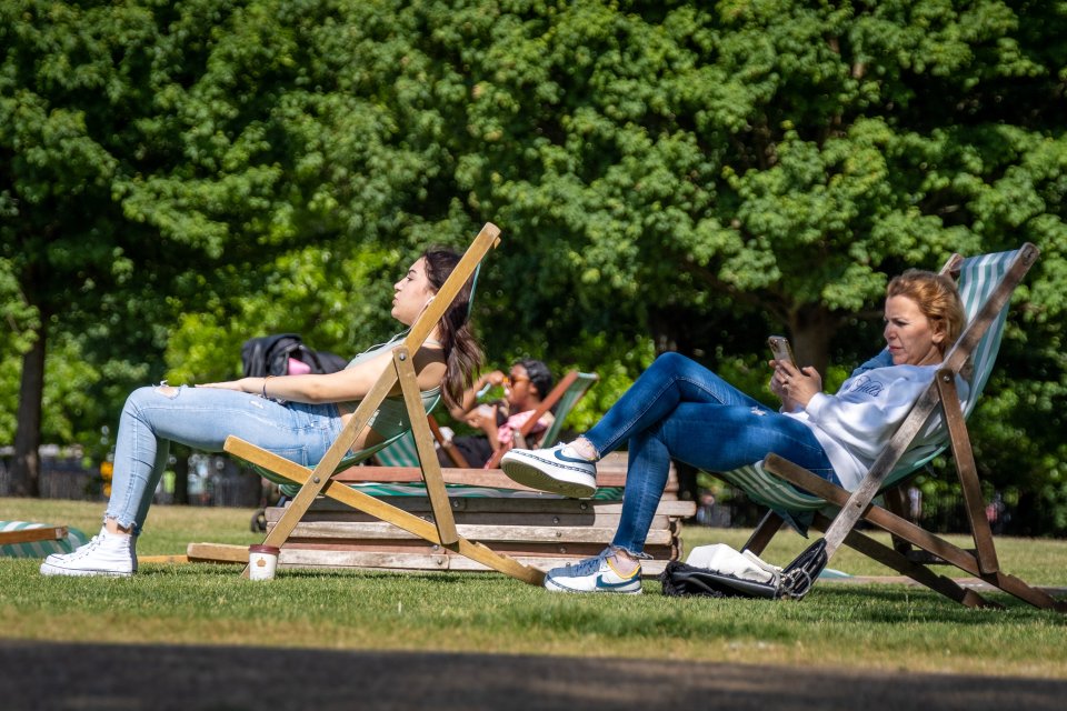 Londoners stretched out in Hyde Park as temperatures rocketed to 25C