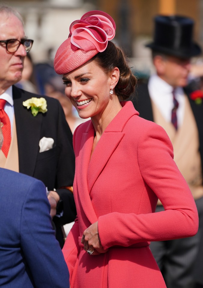 Wearing an Emilia Wickstead dress, Kate smiled as she met guests on the lawn of Buckingham Palace