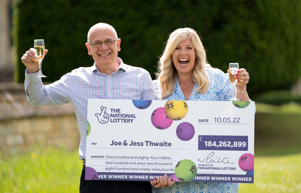 Joe and Jess were all smiles as they posed with their cheque