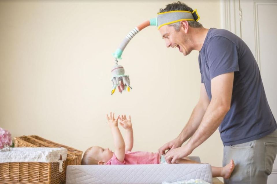 A dad is behind the Dingle Dangle, which helps with nappy changing but doubles as a mobile