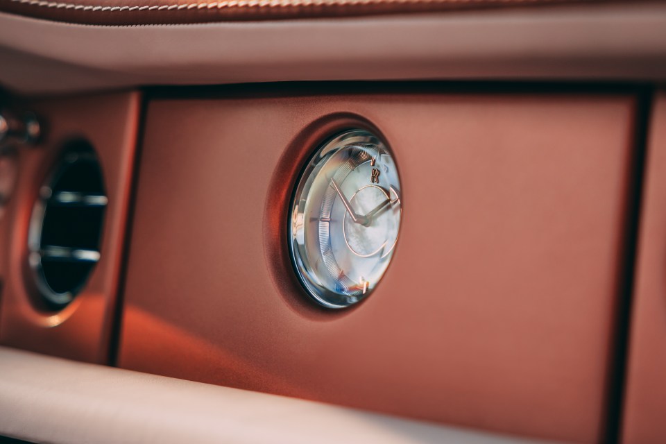 Oyster-coloured leathers and soft rose accents complement the opulent car