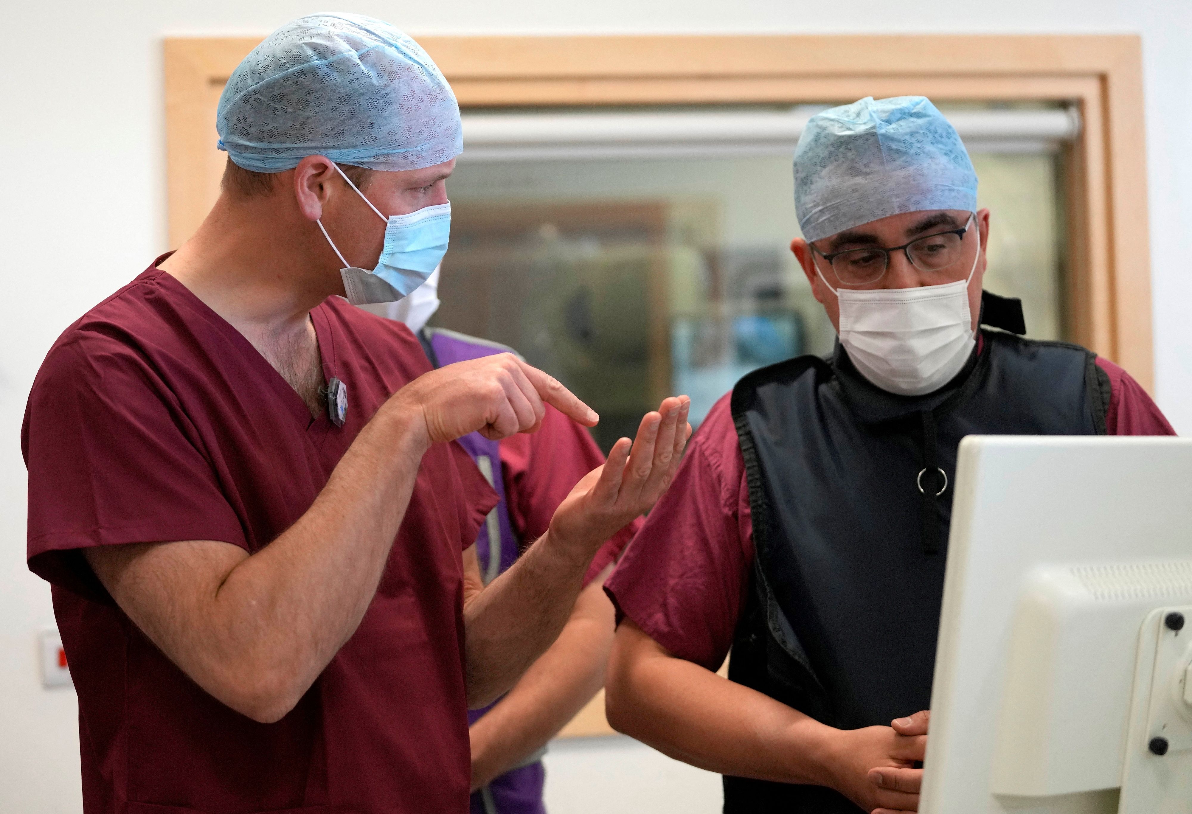 Prince William speaking to Dr Nicos Fotiadis as he visits the Royal Marsden Hospital on May 24, 2022, where he learnt about some of the innovative work that is currently being carried out to improve cancer diagnosis and treatment