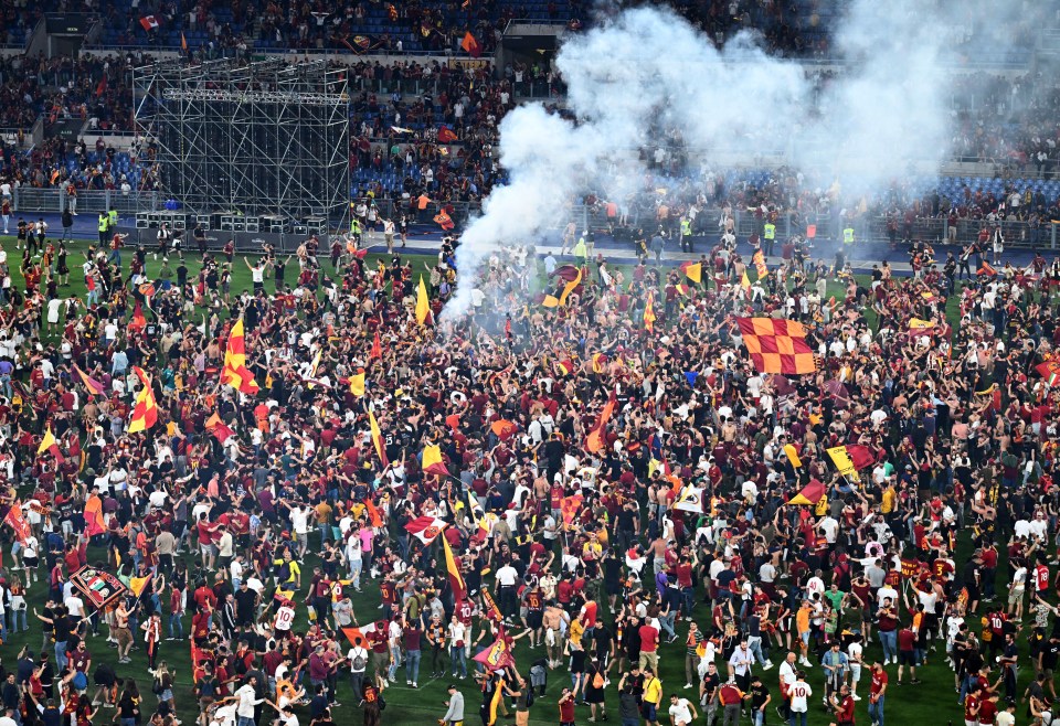 Roma fans ran on to the Stadio Olimpico pitch to celebrate the historic victory