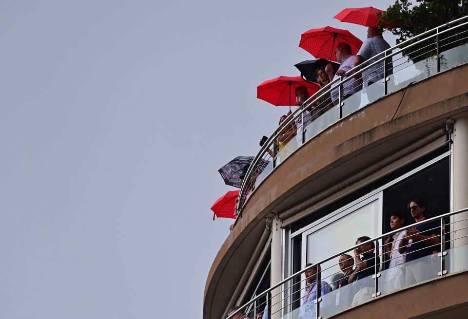 The fans put up their umbrellas during the heavy rain