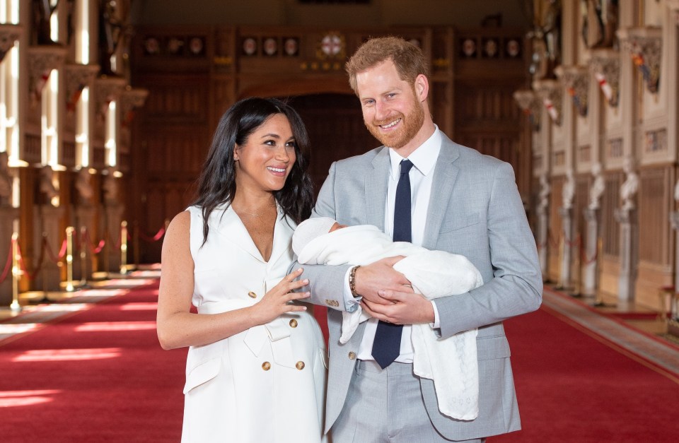 Meghan and Harry pose with their newborn son  during a photocall in St George’s Hall at Windsor Castle shortly after his birth