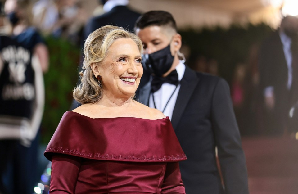 If Hillary Clinton wasn’t obliged to wear a face mask on the red carpet, then why was the flunky who attended to the hem of her red frock?