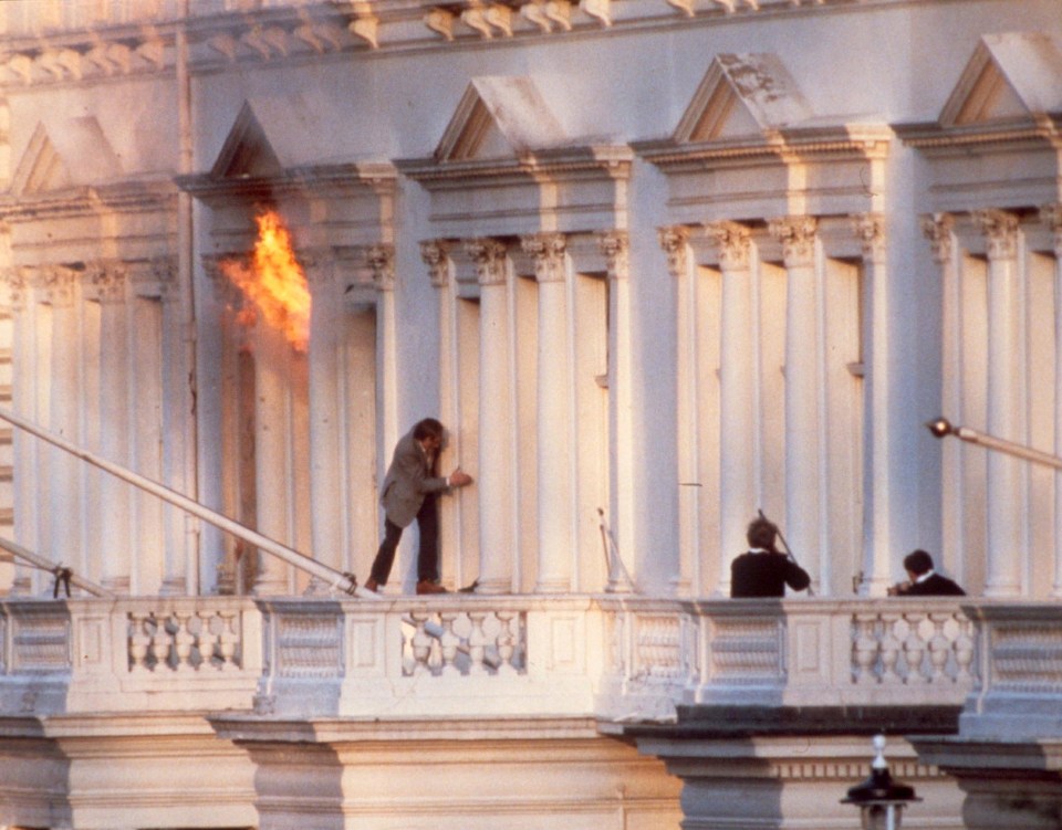 BBC sound recordist Sim Harris darts across the balcony after the SAS storm the building