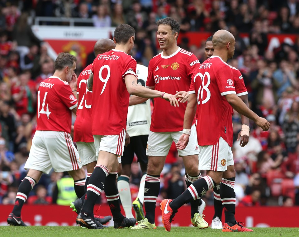 Berbatov receives the support of team-mates after stroking his penalty home