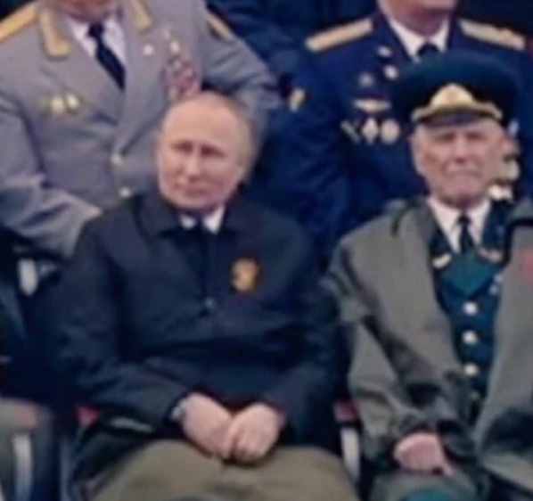 Vladimir Putin watched the parade from under a blanket