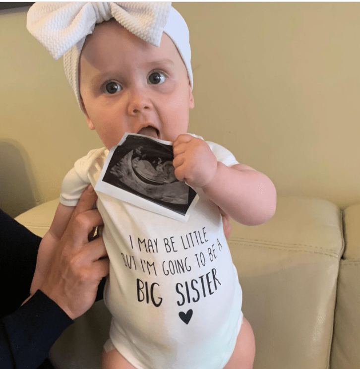 Phillip also shared this sweet snap of his youngest holding a sonogram picture