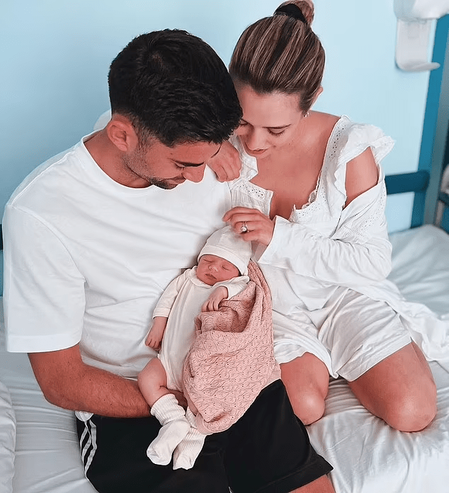 Enzo Zidane and his wife cradle their new baby.