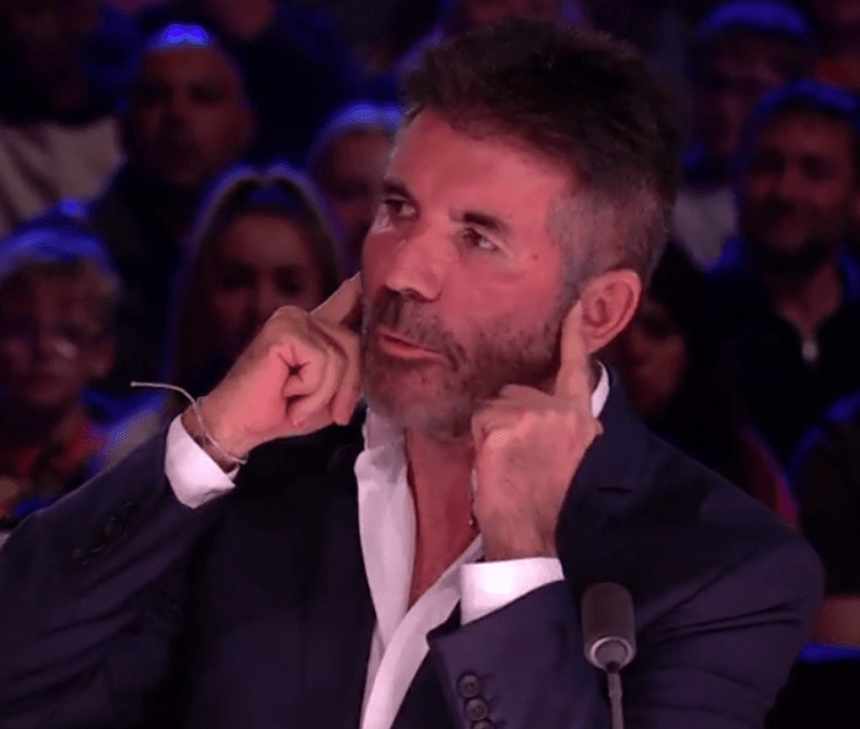 Earlier in the episode Simon Cowell could be seen covering his ears