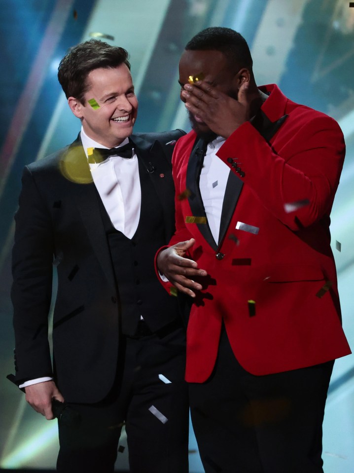 BGT host Declan Donnelly congratulates a tearful Axel after he is announced the winner of the 2022 series