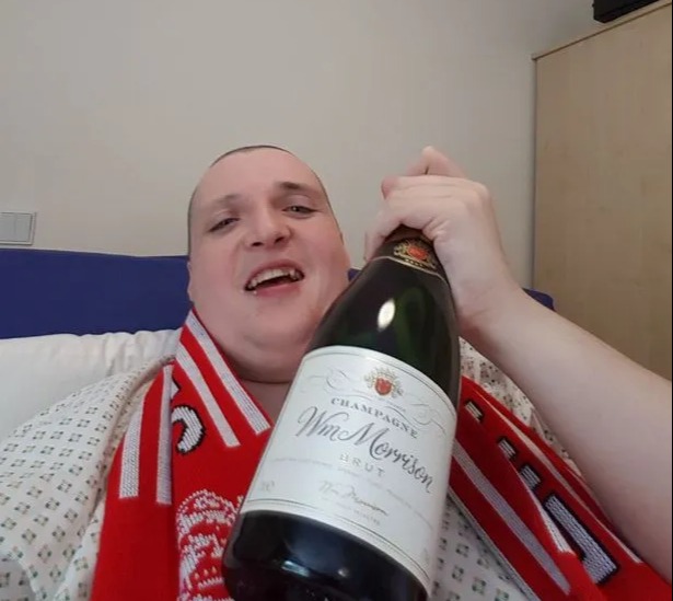 Matthew Crawford posed with champagne during his lengthy hospital stay