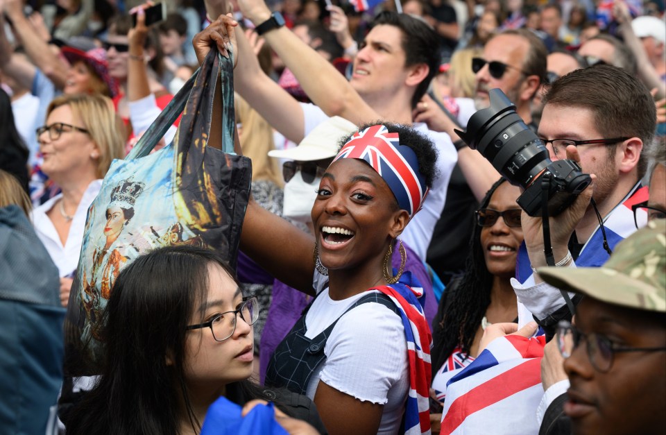 Jubilant crowds gather along the Mall to watch the RAF flypast