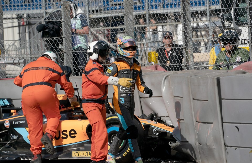 Ricciardo is shepherded away by stewards after crashing his MCL35 during Monaco practice