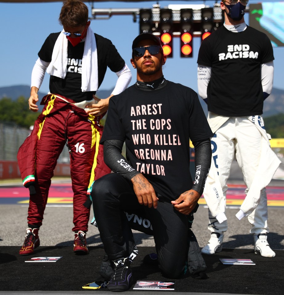 Lewis Hamilton takes a knee on the grid while wearing a shirt in support of Breonna Taylor