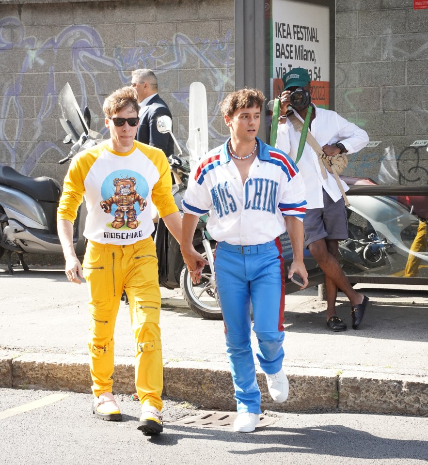 Tom Daley and Dustin Lance Black dressed head to toe in bright Moschino outfits at Milan Fashion Week