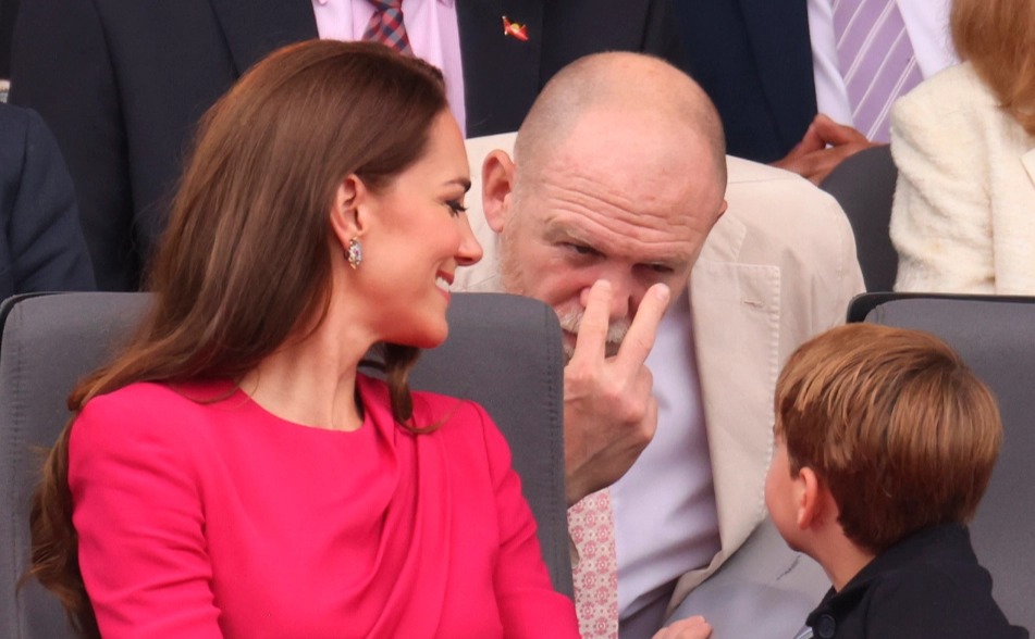 Mike Tindall entertains Louis during the pageant from the row behind