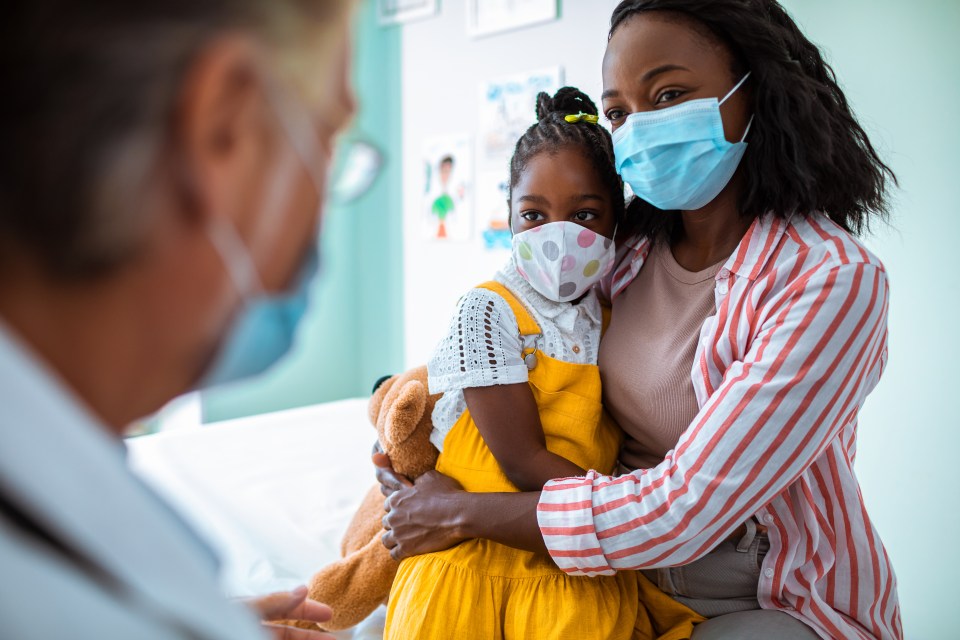 Close up of a mother and daughter having an appointment with the pediatrician