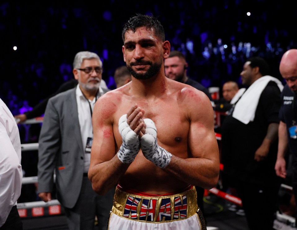 Three men have been charged with robbing Amir Khan