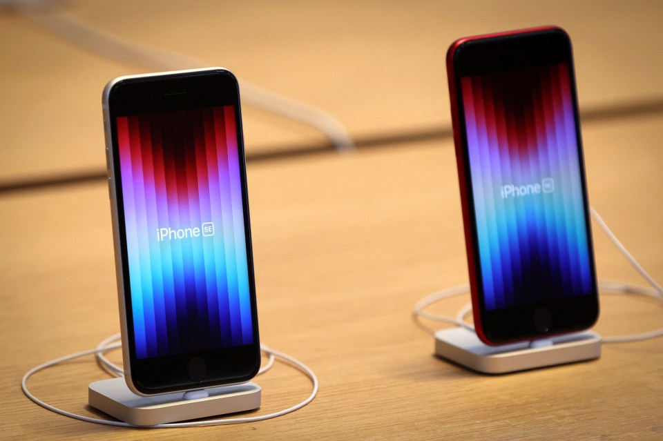 Two iPhones on display at an Apple Store.