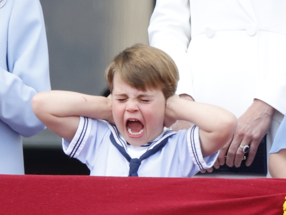 Prince Louis covers his ears during the flypast