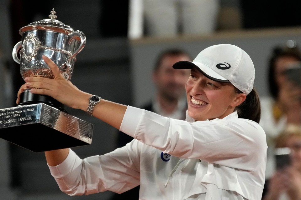 Impressive winner Iga Swiatek was soon smiling again as she lifted the French Open trophy after tears from both finalists