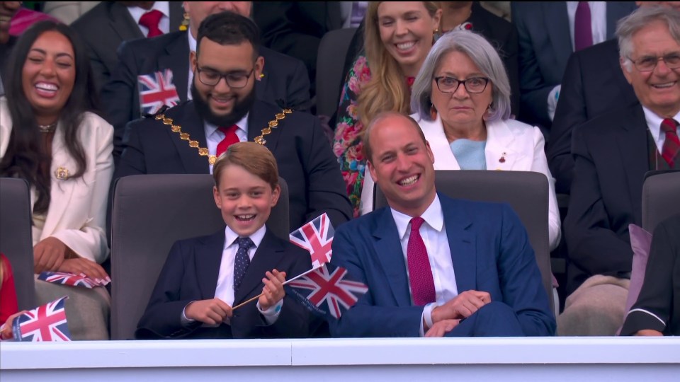 The young prince was seen enthusiastically waving his flag and singing along to Sweet Caroline