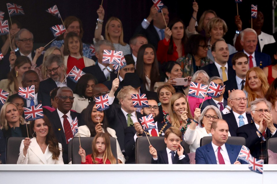 The family waved their flags as the music began