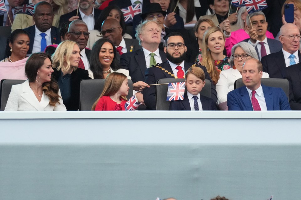 Kate cracked up as Zara poked a Union Jack flag in Prince George’s ear