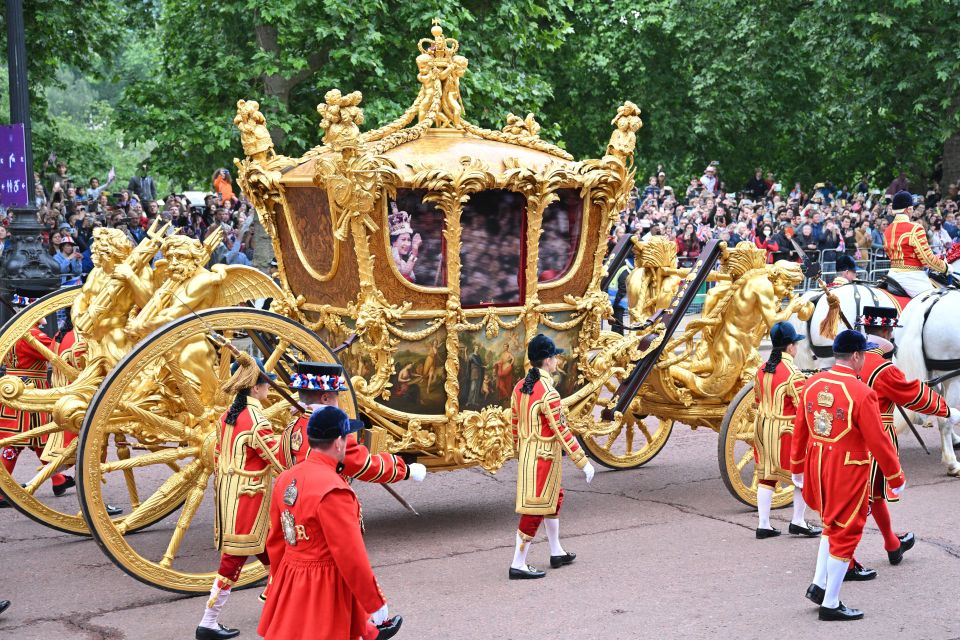 Excited royal fans watched on as the Gold State Coach went by featuring a hologram of the Queen