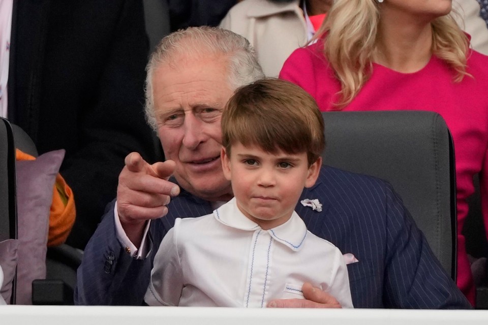 Prince Louis watched part of the show on the lap of grandpa Prince Charles