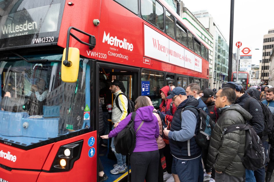 Commuters queued in the rain for busy buses