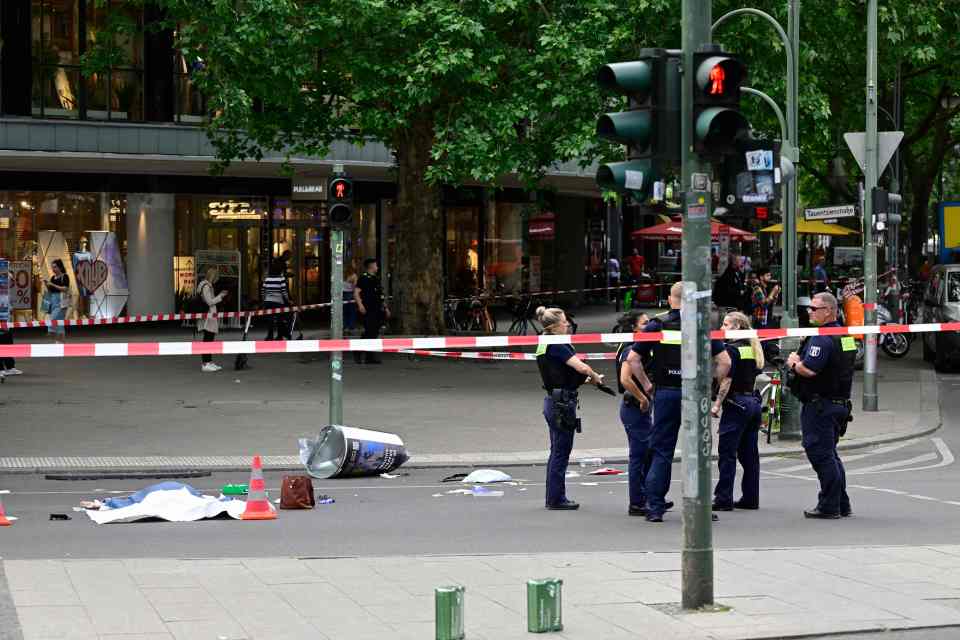 A dead body can be seen covered in a sheet at the scene