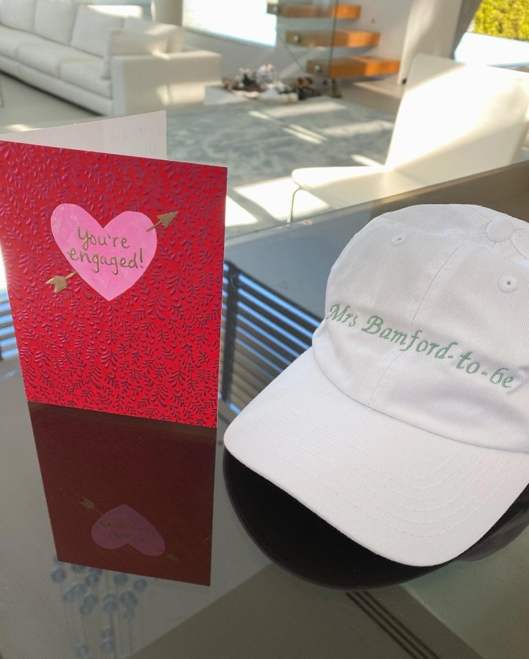 Michaela shows off her engagement card and hat