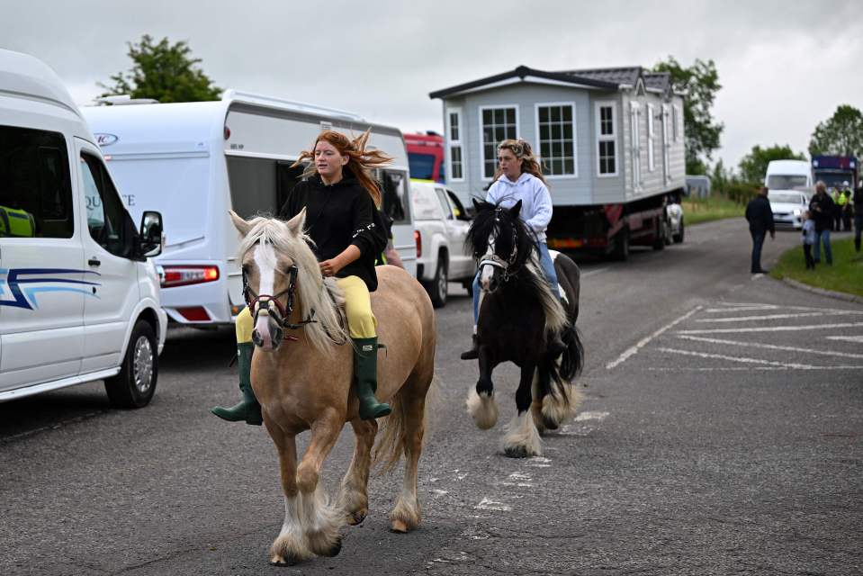 People take their horses for a ride on the first day of the fair