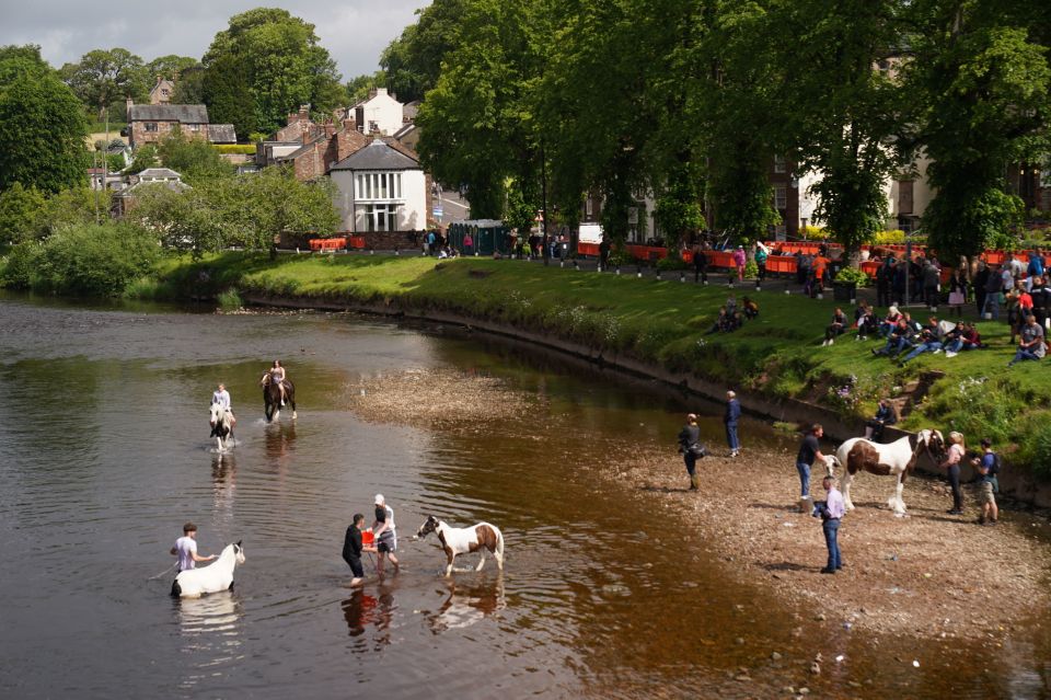 Spectators liked the bank of the river as many people took their horses for a dip