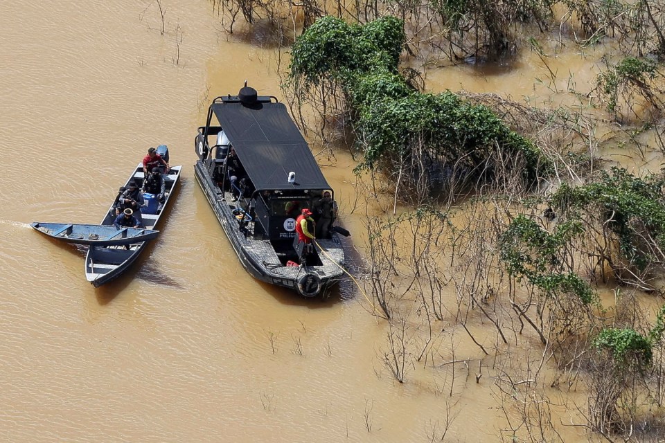 Police officers and rescue team conduct a search operation for the missing duo