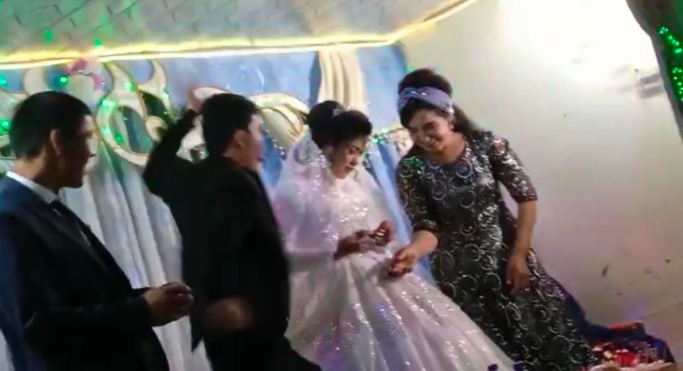 The video shows a bride allegedly punching his bridge in the head