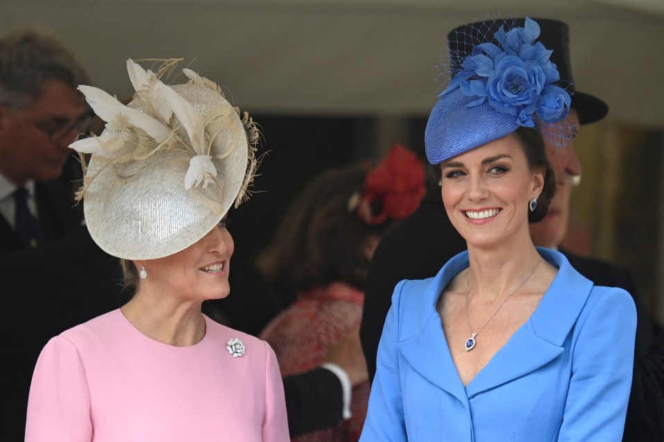 Sophie, Countess of Wessex, and Kate beam in pink and blue