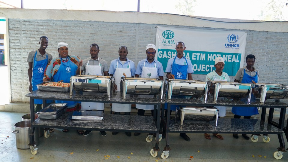 Catering staff pose in front of lunch