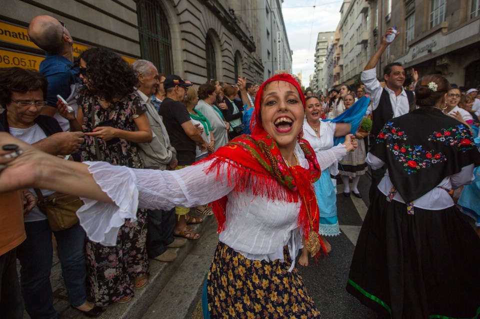 Festa de Sao Joao do Porto sees thousands gather in the streets to bash each other with soft plastic hammers to drive out evil spirits