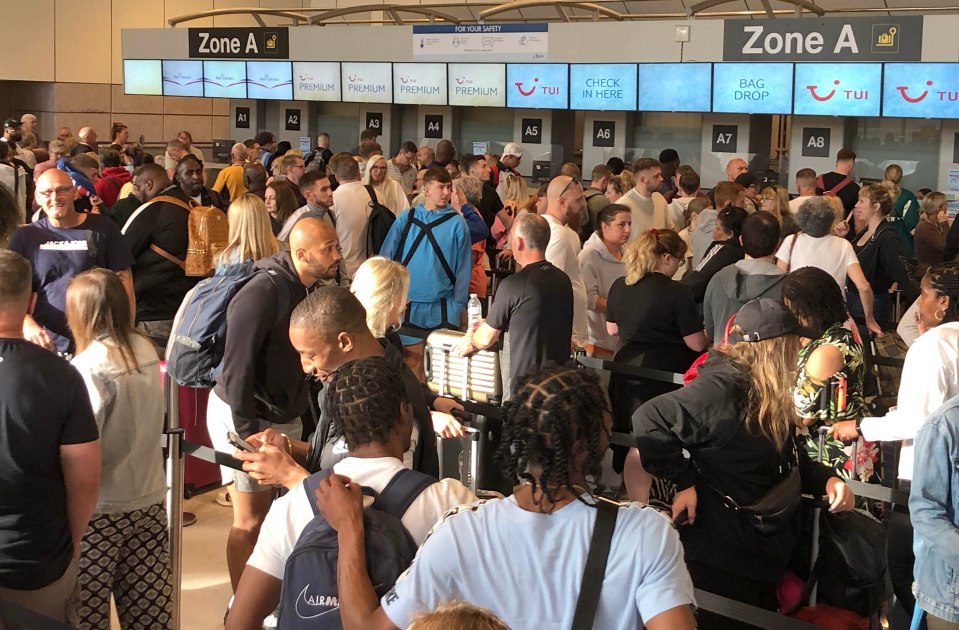 Early morning queues at the TUI desks at Manchester Airport