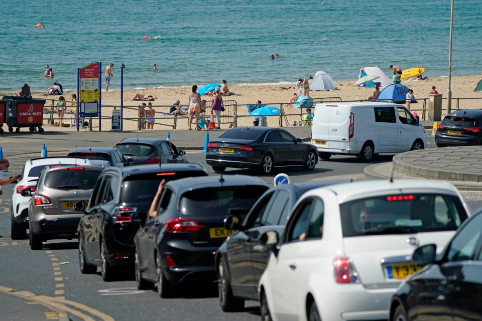 Cars queue up to park at Boscombe Beach in Dorset